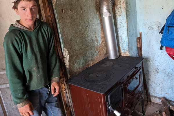 A Young Man Posing with His Family's New Stove