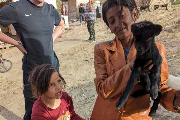 Villager Showing Her Black Lamb